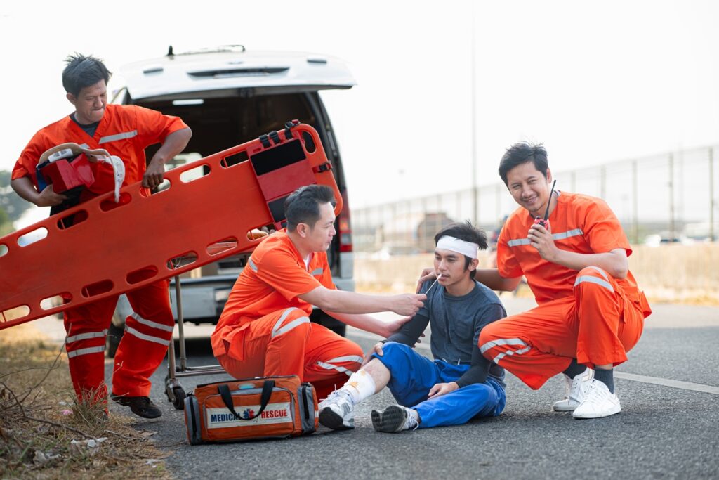 Emergency responders helping a car accident victim