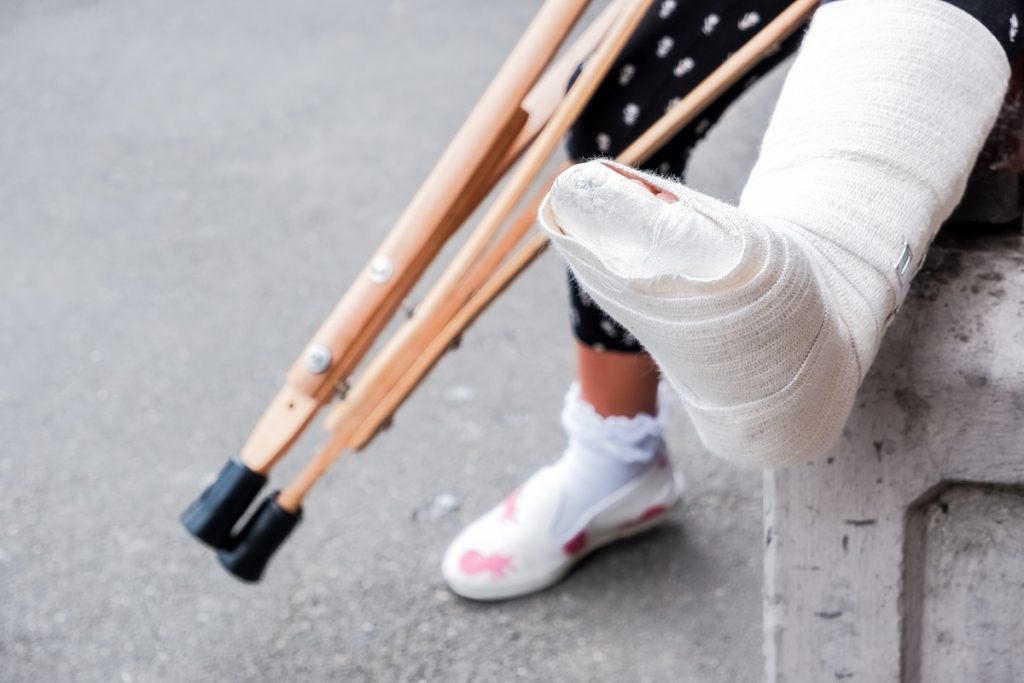 An injured person with crutches and a cast