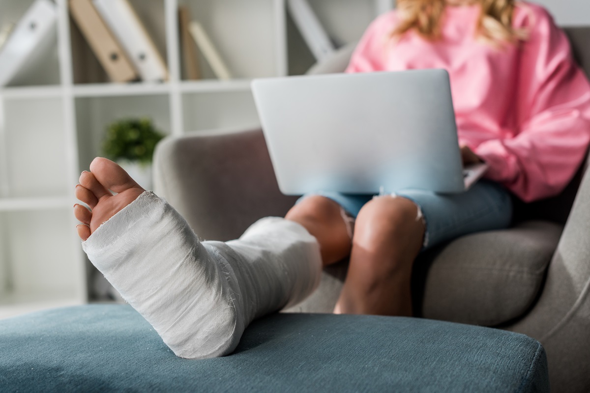An injured person working on a laptop