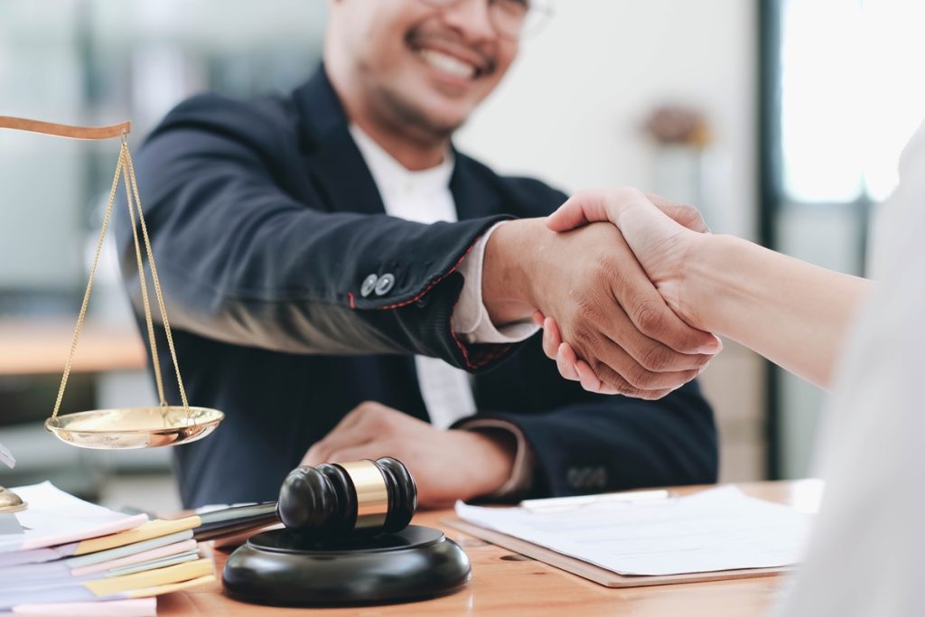 A lawyer shaking hands with a client