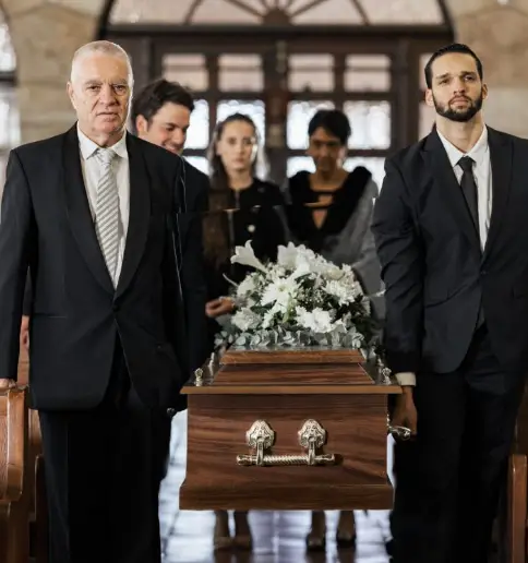 Pallbearers carrying a casket at a funeral