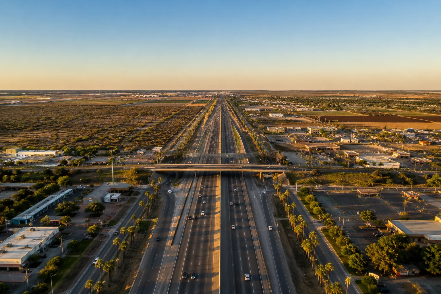 Aerial view of a Rio Grande Valley highway corridor at golden hour, the road network behind the RGV crash statistics 2026 report