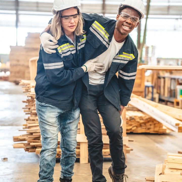 Weslaco Workplace Injury Lawyer A worker assisting an injured coworker